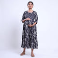 Black printed maternity wear with empire waist and three quarter sleeves front view 