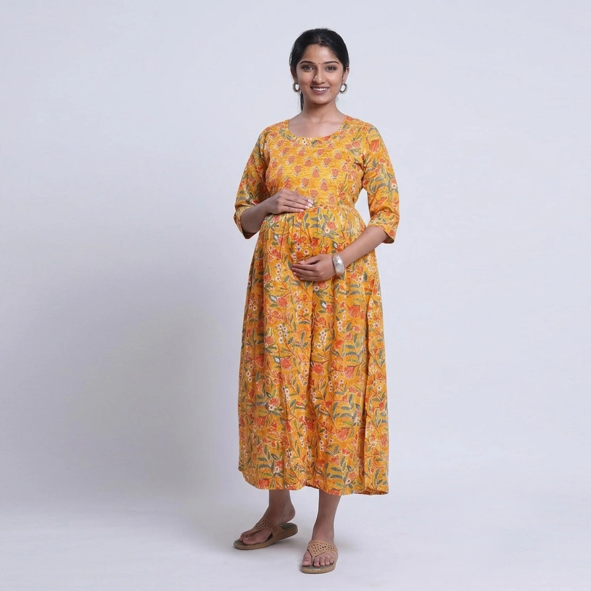 Yellow printed maternity wear with empire waist and three quarter sleeves front view 