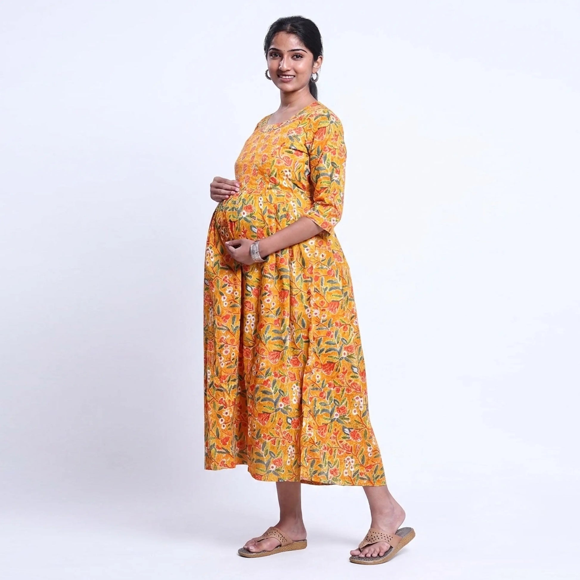 Yellow printed maternity wear with empire waist and three quarter sleeves front view 