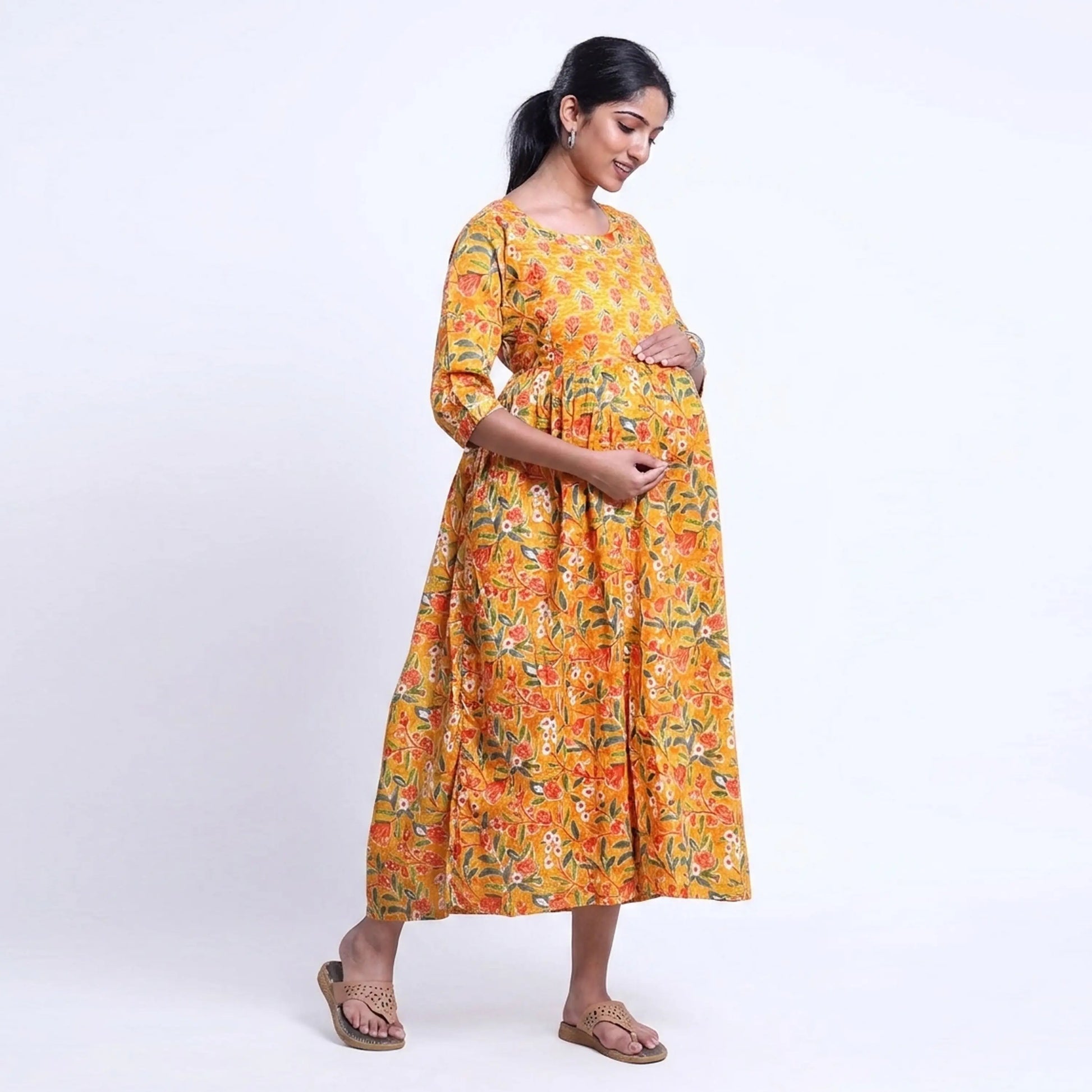 Yellow printed maternity wear with empire waist and three quarter sleeves front view 
