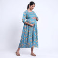 Blue printed maternity wear with empire waist and three quarter sleeves front view 