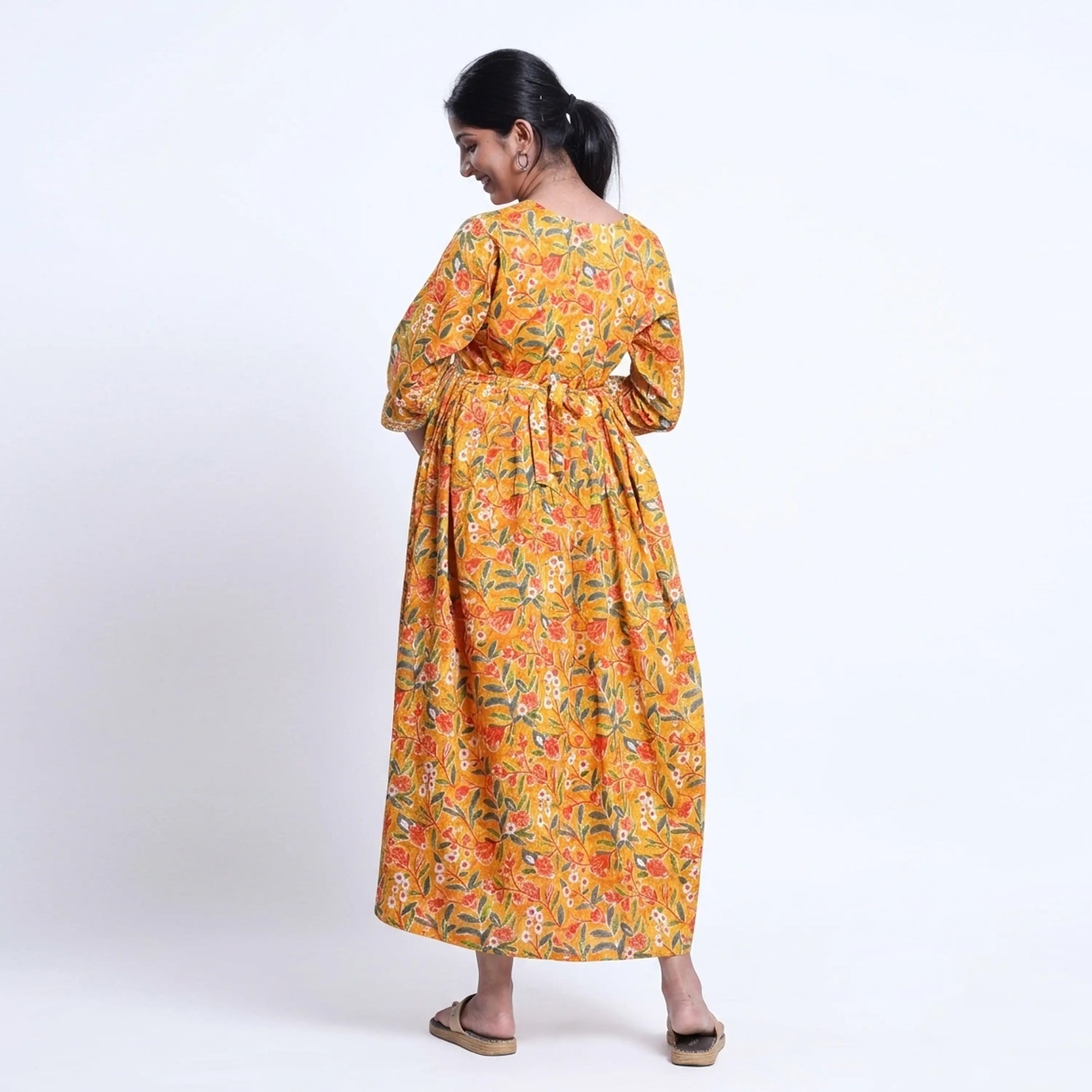 Yellow printed maternity wear with empire waist and three quarter sleeves front view 