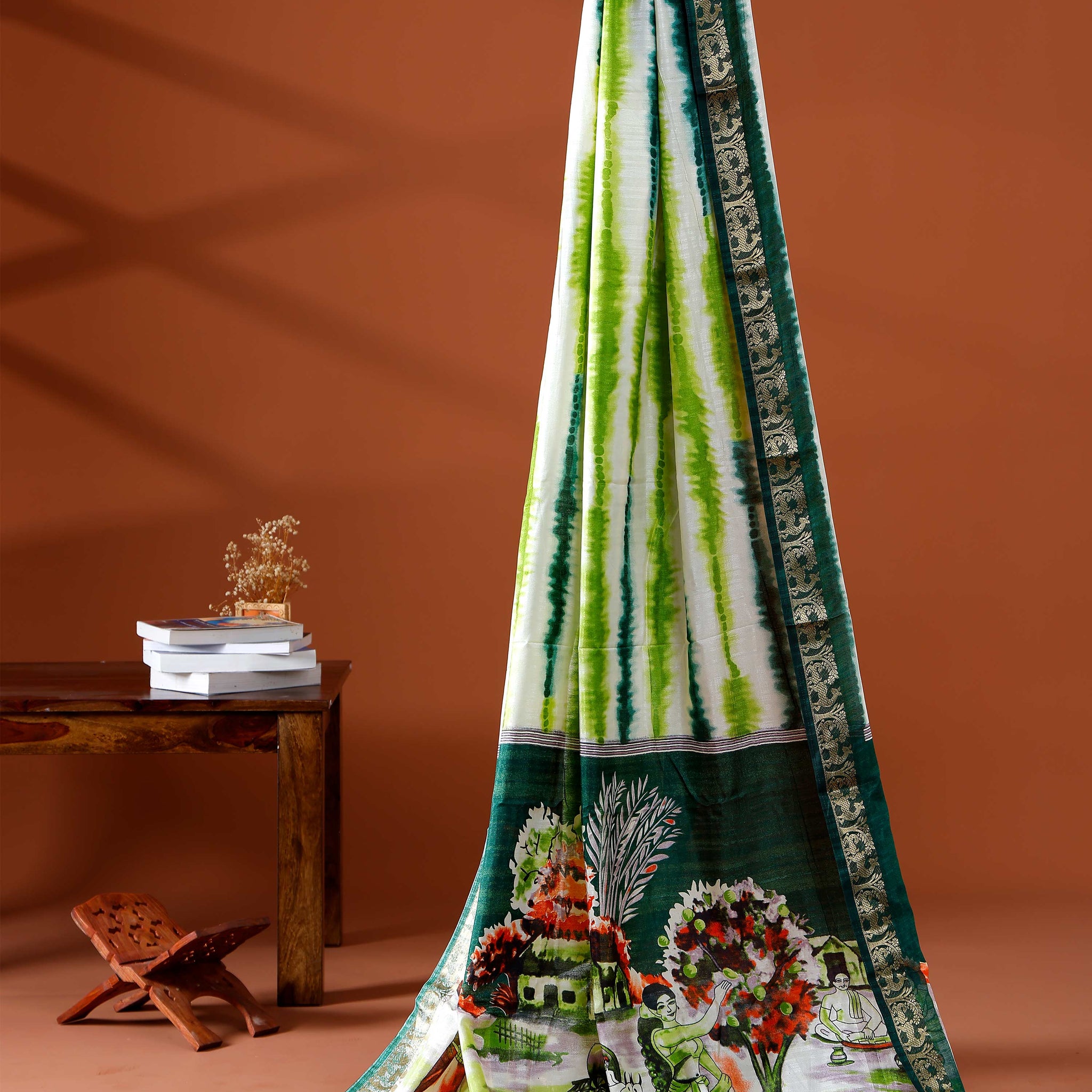 Elegant green shades and the rural scenic artwork Dola Saree