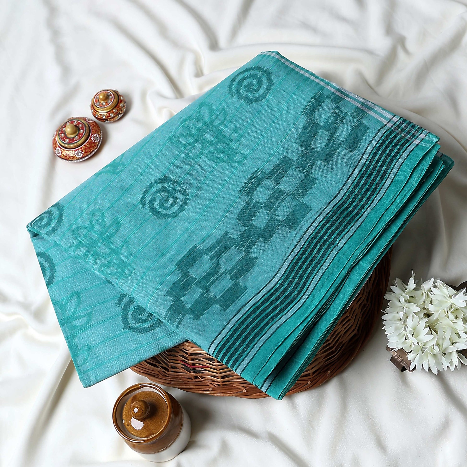 Bengal Cotton Saree With Geometric and Floral Motifs In Aqua Blue Folded Close Up Display View