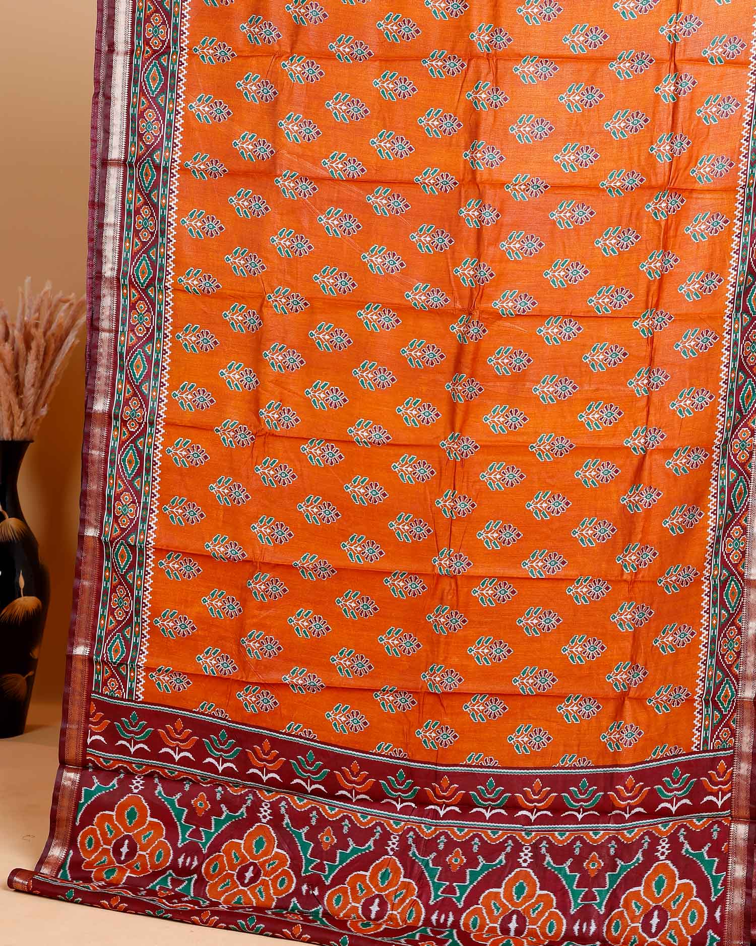 Rich Orange Patola Silk Saree with Intricate Floral Motifs and Black Contrast Pallu