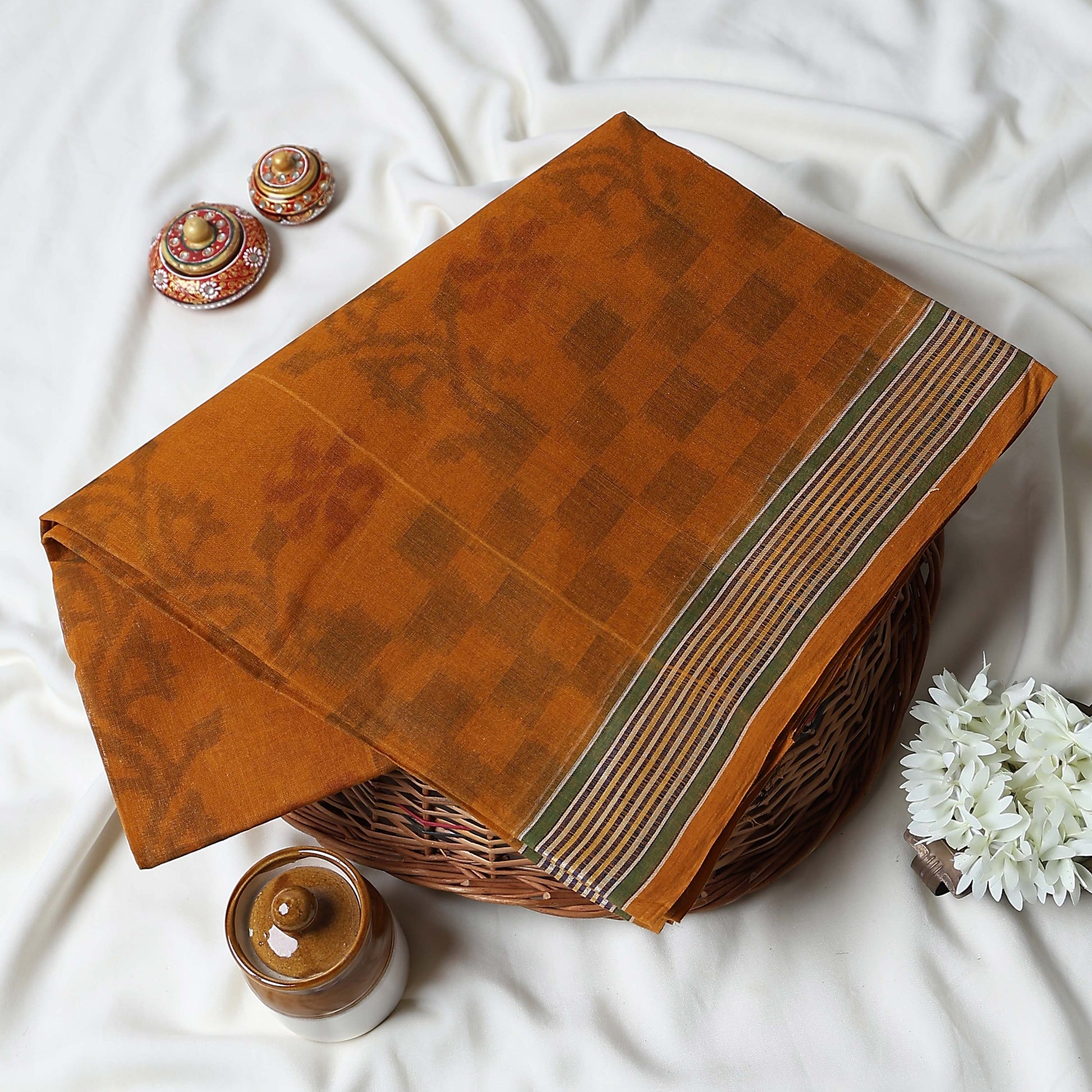 Bengal Cotton Saree With Floral Woven Motifs, Checked Pattern And Striped Border In Dark Orange Top Folded View
