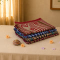 Voile cotton saree stack collection with abstract striped floral prints in multicolor folded tabletop display view
