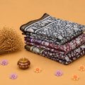 Semi Chanderi saree with floral print in grey and multicolor folded stack close up product view.