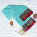 Aqua Blue Mangalagiri Cotton Saree With Intricate Geometric Zari Border And Red Edging Close Up Folded View
