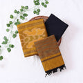 Top View Of Mustard And Black Salwar Suit Material With Striped Dupatta, Ikkat Woven Border, Tassel Details & Fabric Piece