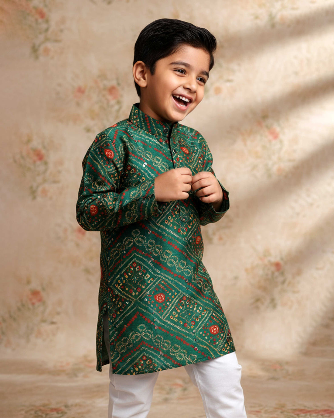Boys green kurta adorned with traditional Bandhani-inspired patterns in red and gold.