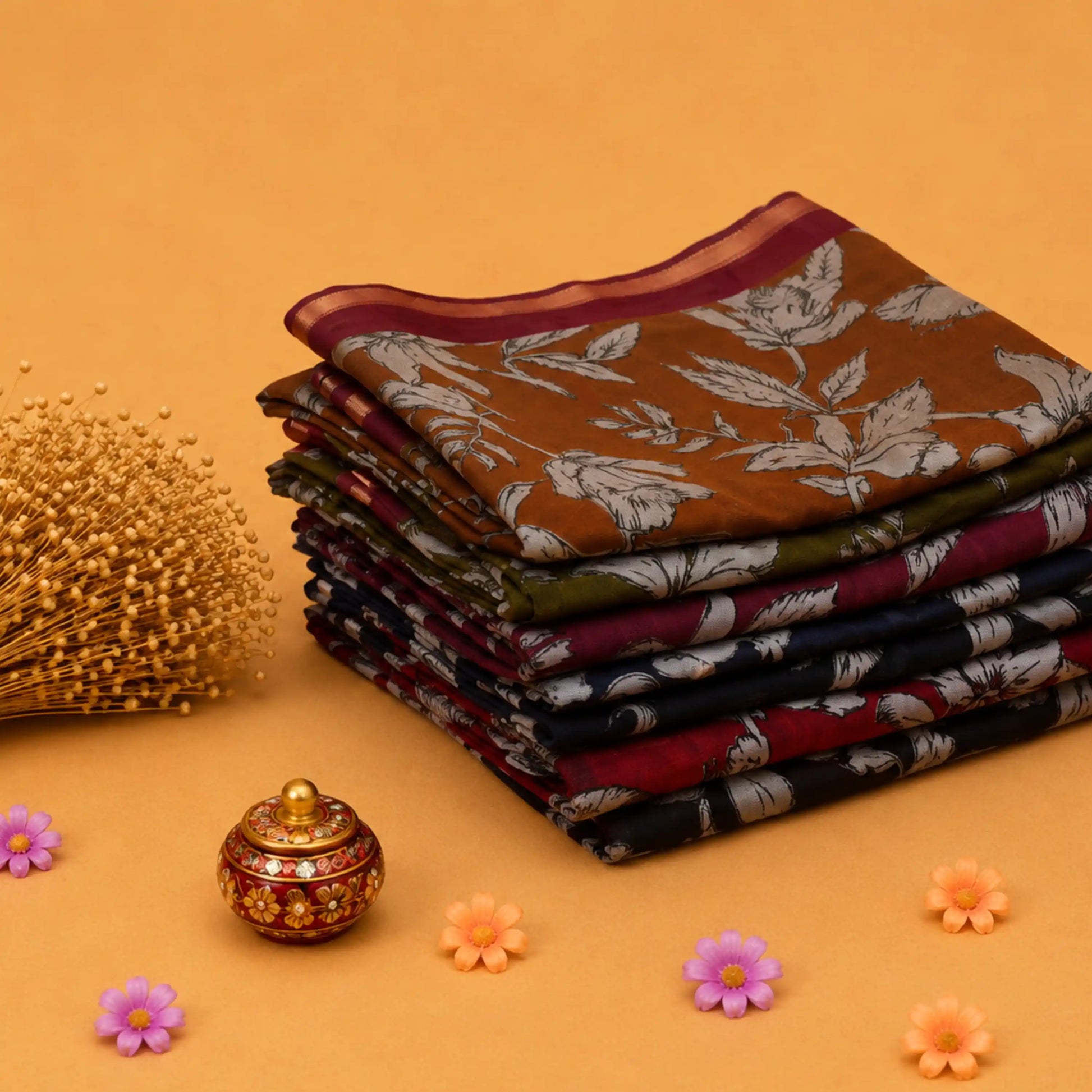 Semi Chanderi saree collection with floral printed designs in assorted colors folded stack front angled view