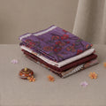 Tussar saree with multicolor artistic print, green woven border, neatly folded stack front view