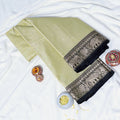 Mangalagiri Cotton Saree With Zari Woven Black Border In Light Green Neatly Folded Flat Lay View