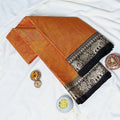 Mangalagiri Cotton Saree With Zari Woven Black Border In Orange Neatly Folded Flat Lay View