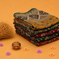 Stack of Semi Chanderi sarees with multicolor Kalamkari floral patterns folded angled product display.