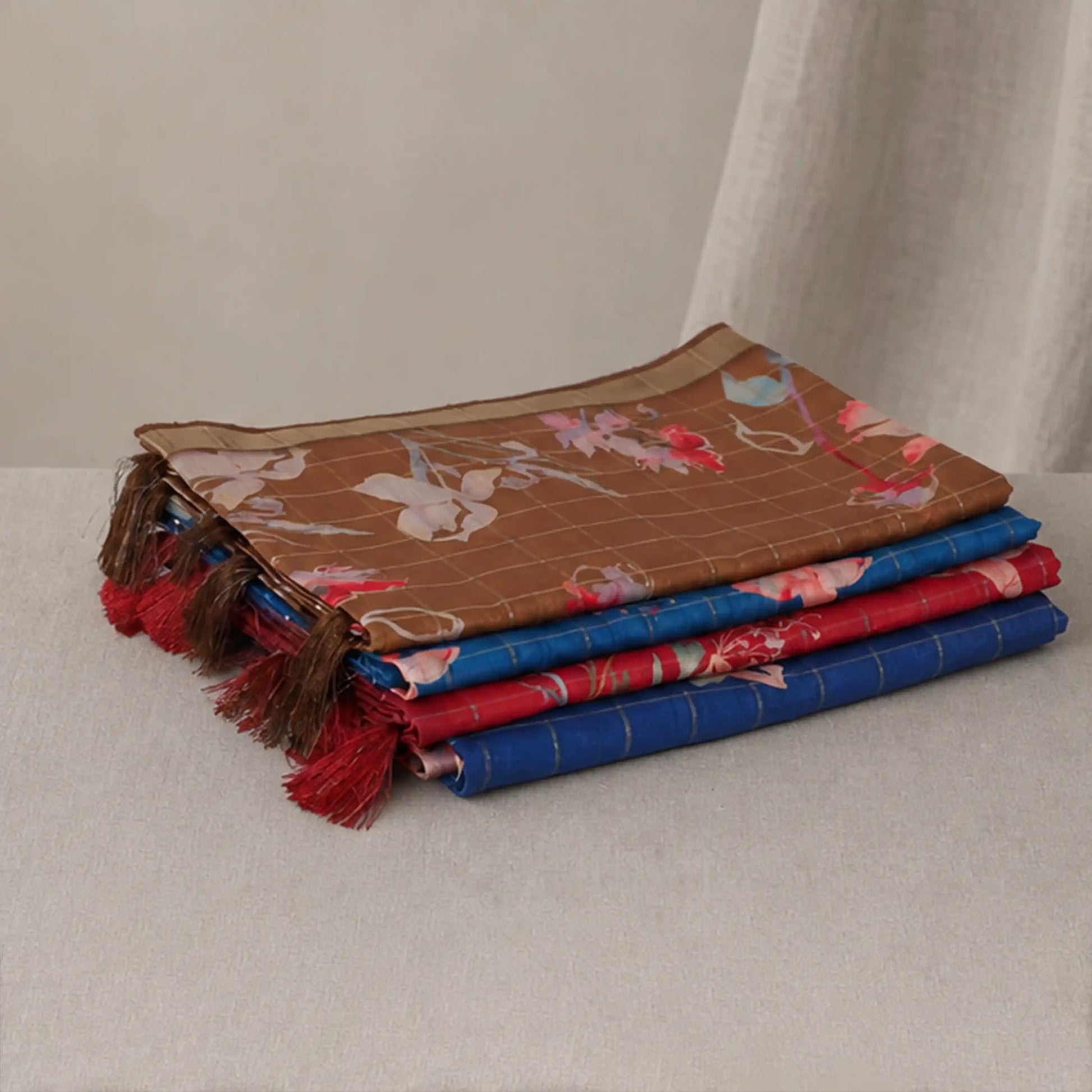 Tussar saree with multicolor artistic print, green woven border, neatly folded stack front view
