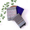 Top View Of Ash Grey And Blue Salwar Suit Material With Striped Dupatta, Ikkat Woven Border, Tassel Details & Fabric Piece