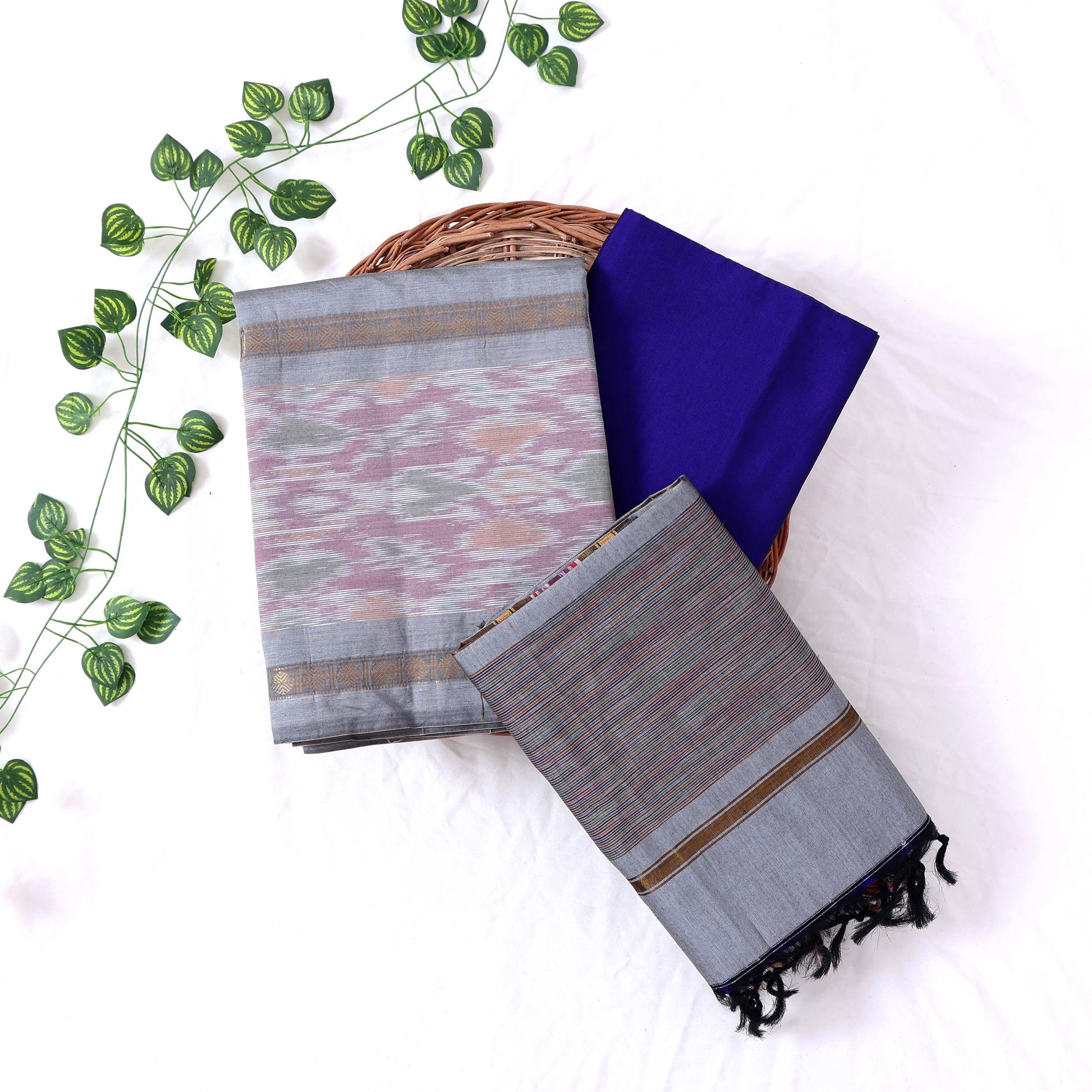 Top View Of Ash Grey And Blue Salwar Suit Material With Striped Dupatta, Ikkat Woven Border, Tassel Details & Fabric Piece