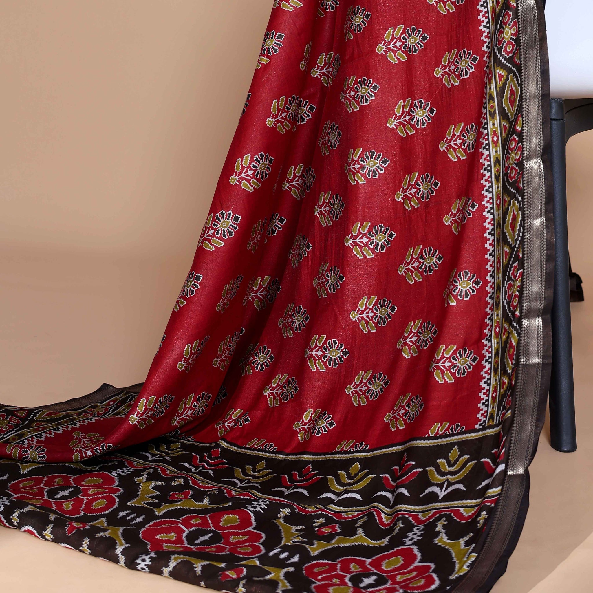 Rich Maroon Patola Silk Saree with Intricate Floral Motifs and Black Contrast Pallu