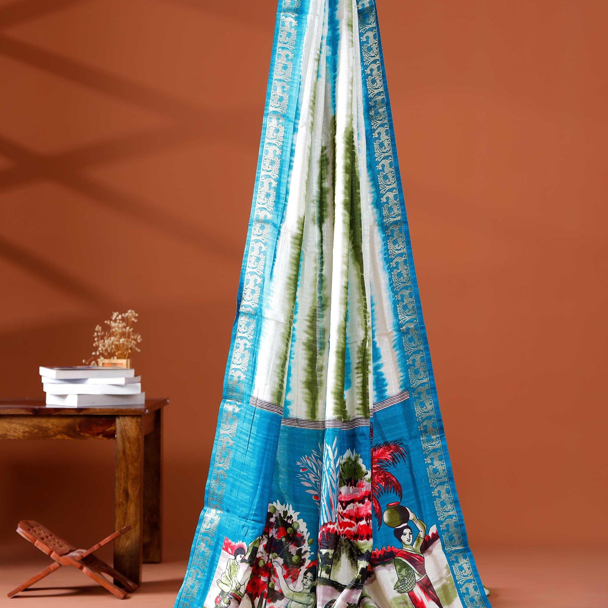 Elegant Blue shades and the rural scenic artwork Dola Saree