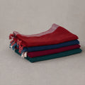 Tussar saree with multicolor artistic print, green woven border, neatly folded stack front view