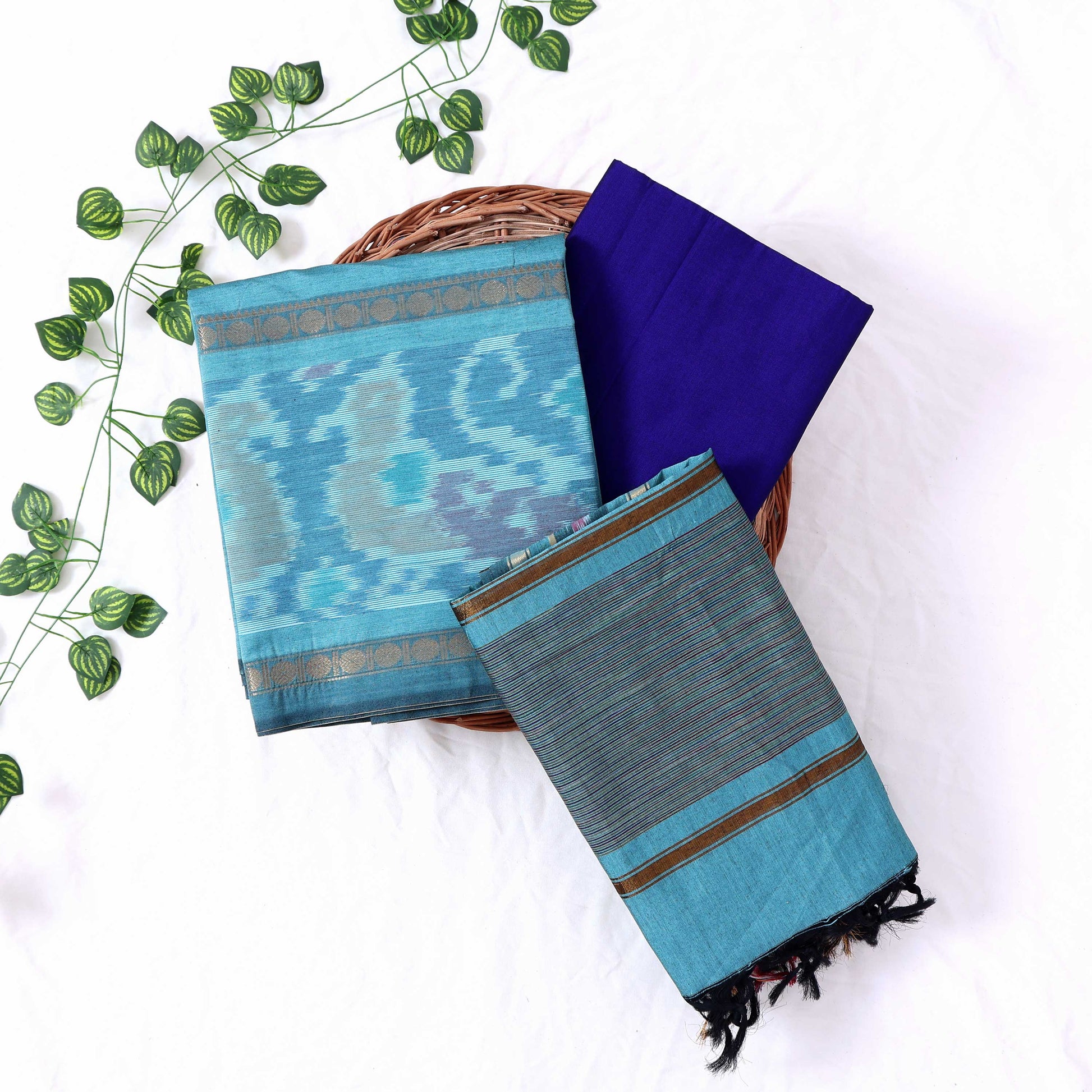 Top View Of Aqua Blue And Blue Salwar Suit Material With Striped Dupatta, Ikkat Woven Border, Tassel Details & Fabric Piece