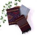 Top View Of Deep Maroon And Grey Salwar Suit Material With Striped Dupatta, Ikkat Woven Border, Tassel Details & Fabric Piece