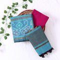 Top View Of Light Blue And Pink Salwar Suit Material With Striped Dupatta, Ikkat Woven Border, Tassel Details & Fabric Piece