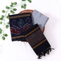 Top View Of Navy Blue And Grey Salwar Suit Material With Striped Dupatta, Ikkat Woven Border, Tassel Details & Fabric Piece