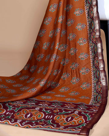 Rich Orange Patola Silk Saree with Intricate Floral Motifs and Black Contrast Pallu