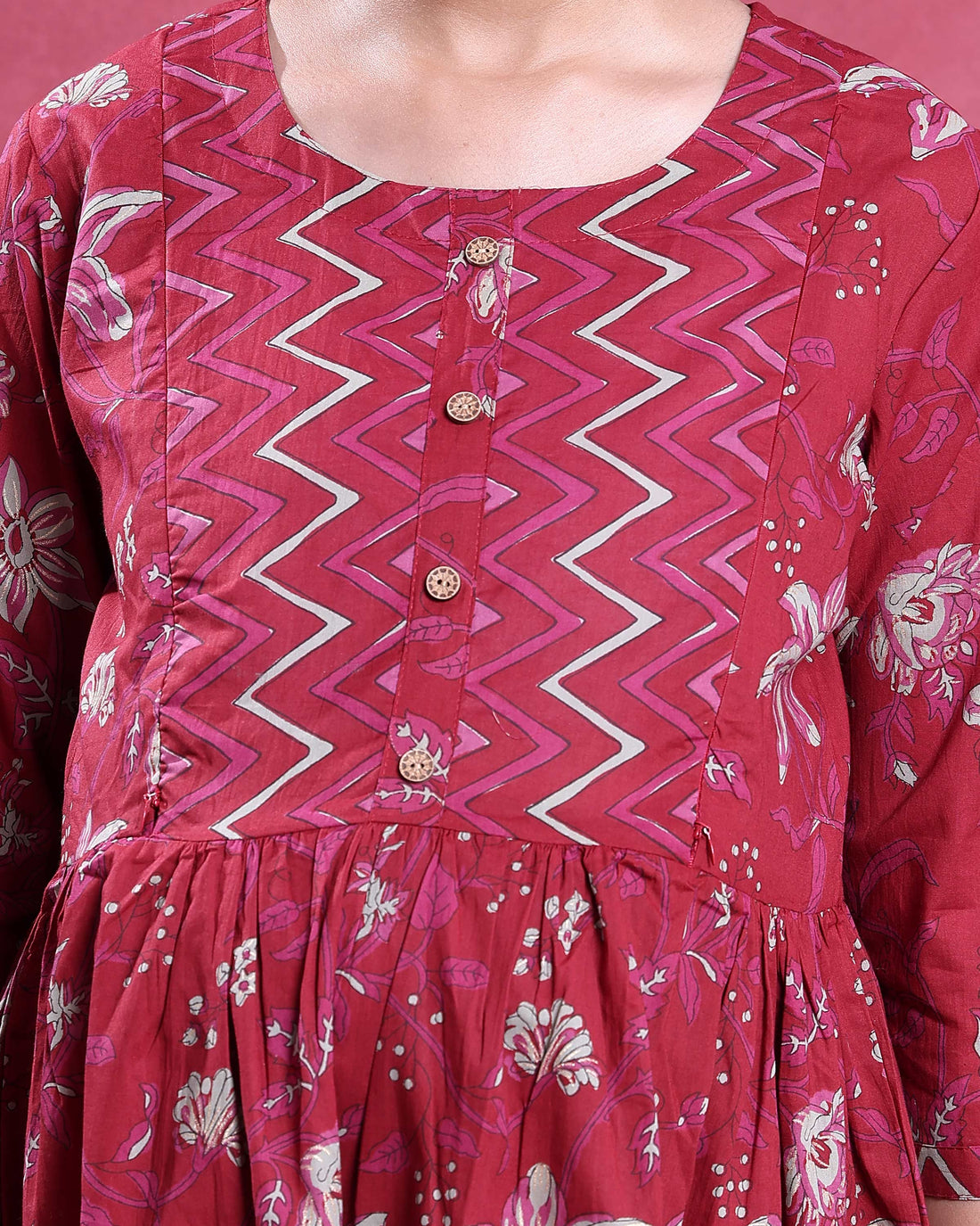 Full length front view of a maroon maternity dress with floral print gathered waist button placket and three quarter sleeves