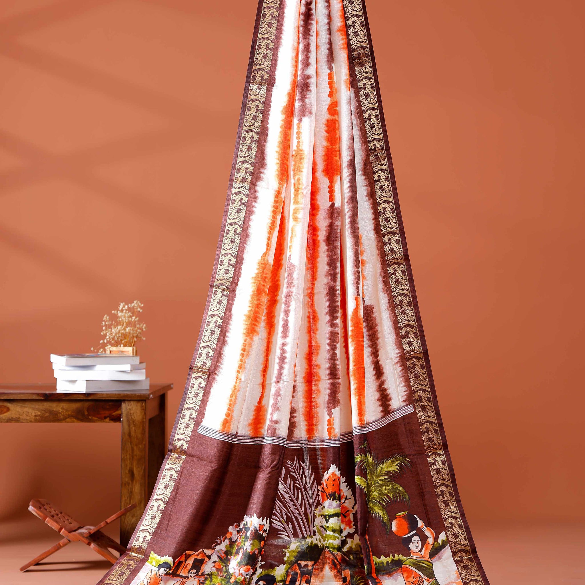 Elegant Brown shades and the rural scenic artwork Dola Saree