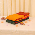 Yellow and green Sungudi cotton saree featuring woven checks and red zari border folded view