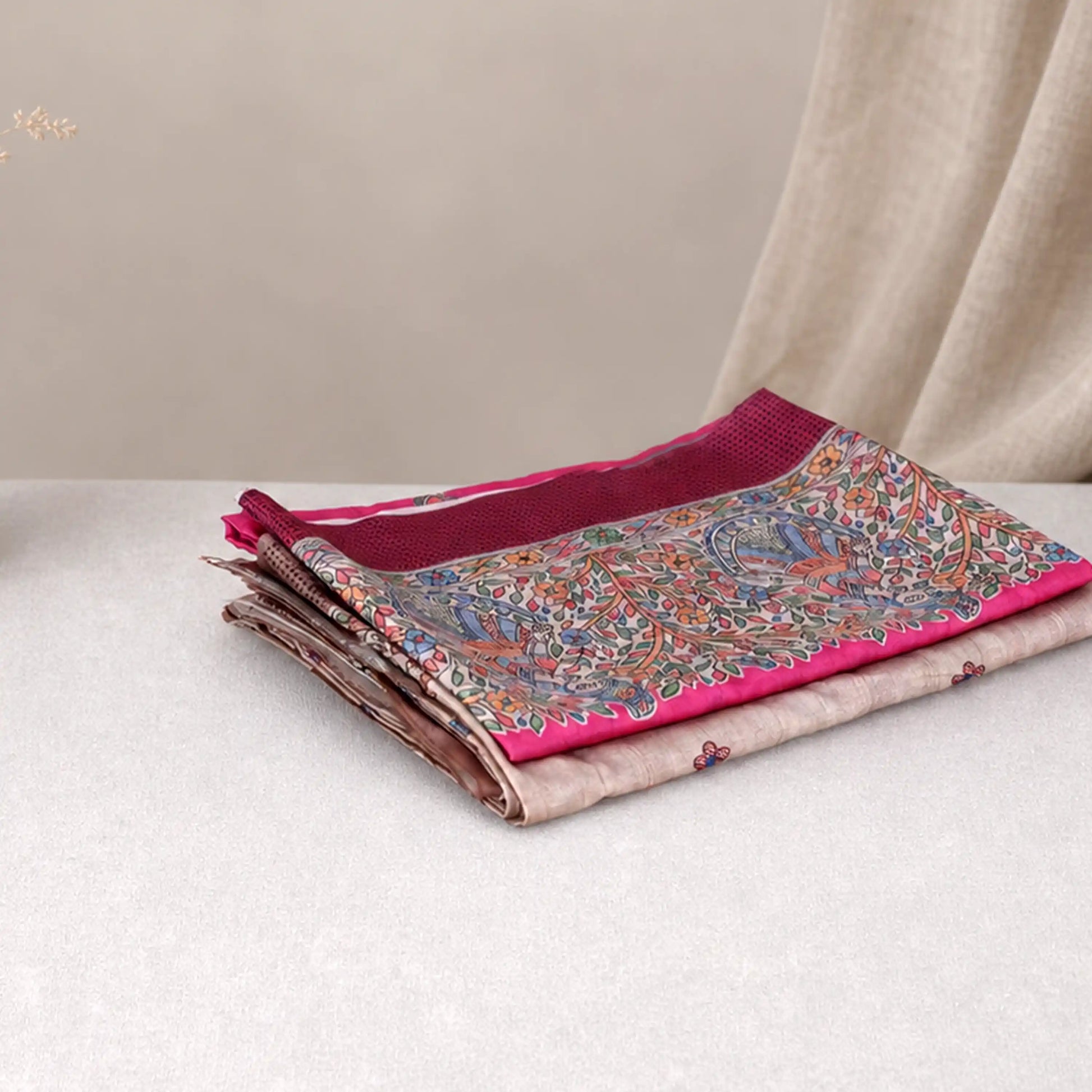 Tussar saree with multicolor artistic print, green woven border, neatly folded stack front view