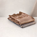 Tussar saree with multicolor artistic print, green woven border, neatly folded stack front view