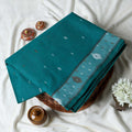 Bengal Cotton Saree With Woven Buti Motifs And Contrast Border In Teal Folded Display  - Close Up View