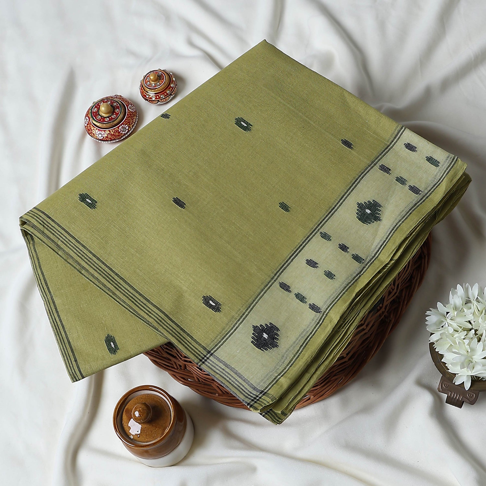 Bengal Cotton Saree With Woven Buti Motifs And Contrast Border In Light Green Folded Display  - Close Up View
