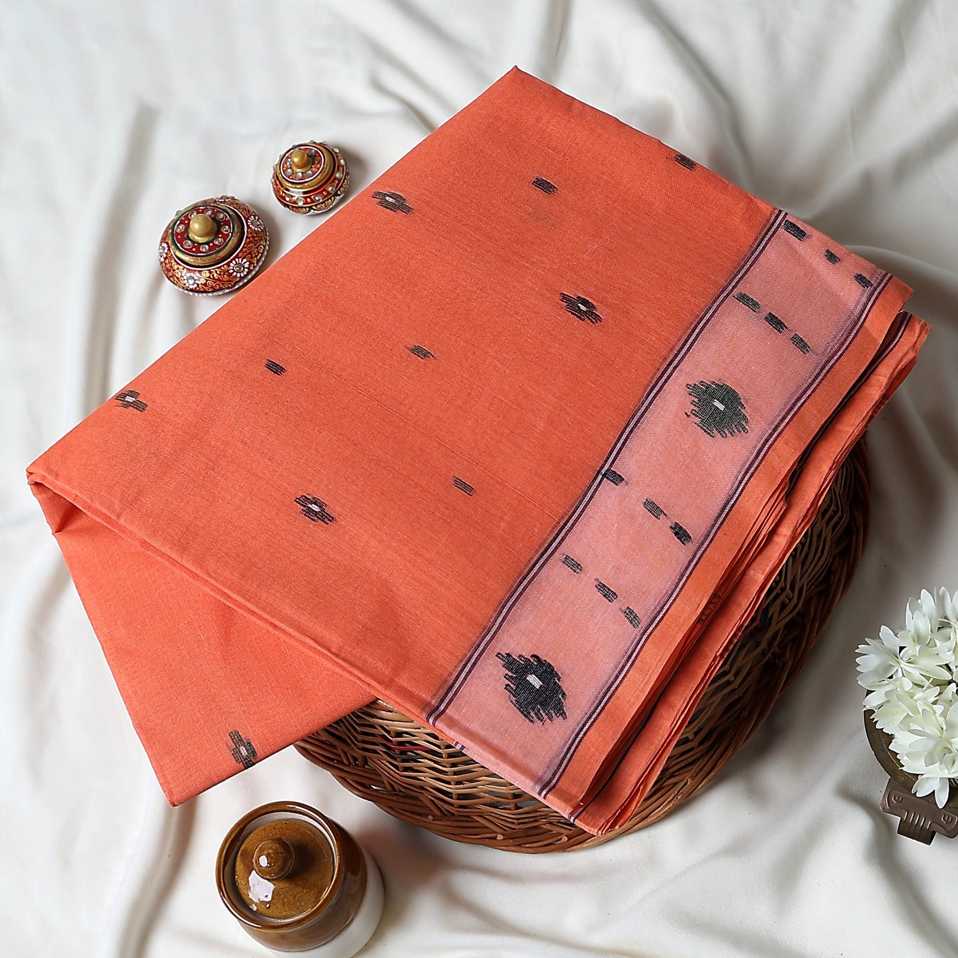 Bengal Cotton Saree With Woven Buti Motifs And Contrast Border In Light Orange Folded Display  - Close Up View