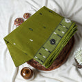 Bengal Cotton Saree With Woven Buti Motifs And Contrast Border In Green Folded Display  - Close Up View
