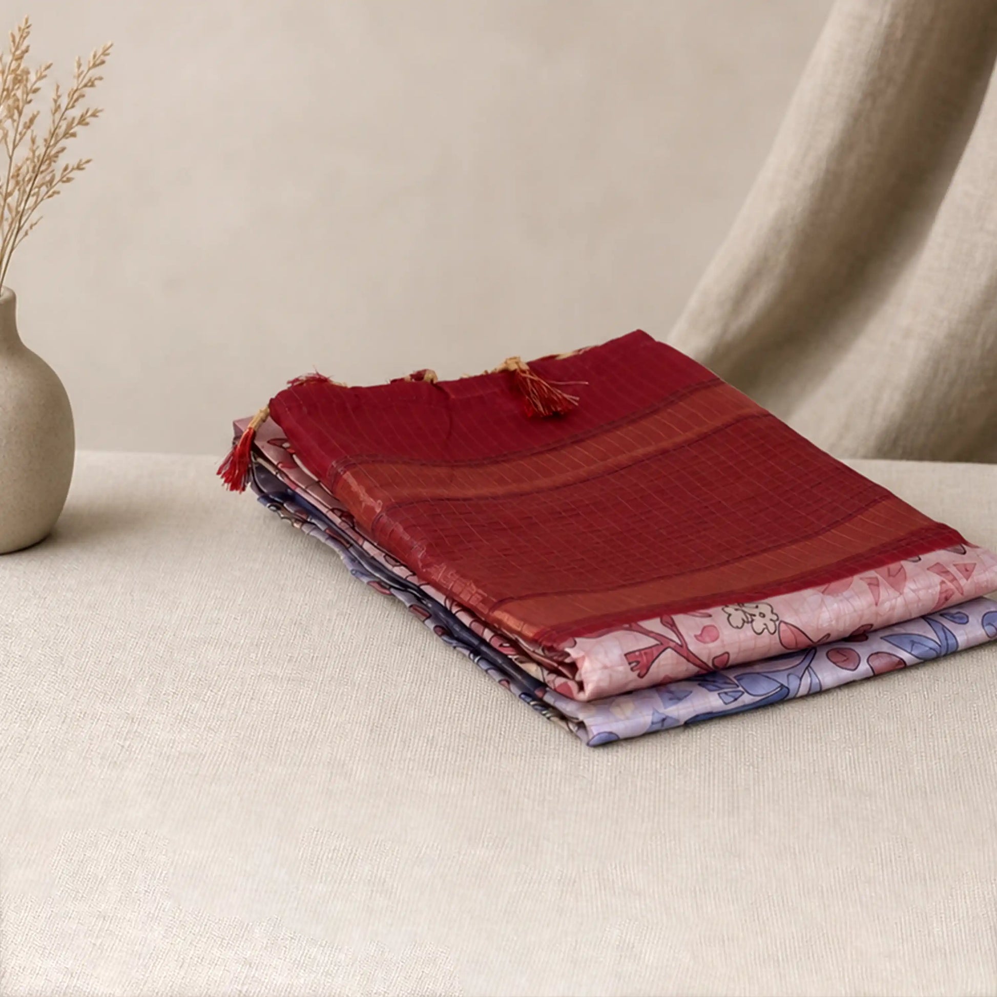 Tussar saree with multicolor artistic print, green woven border, neatly folded stack front view
