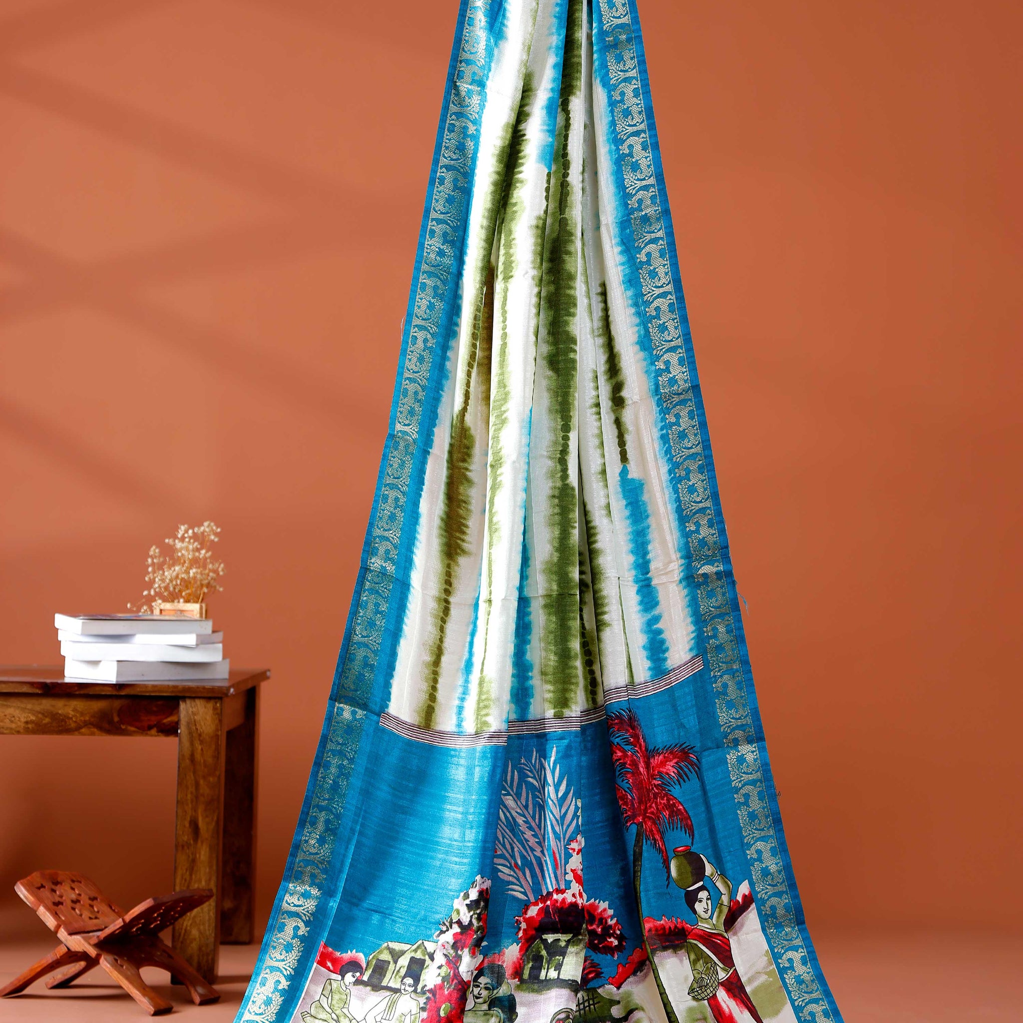 Elegant Blue shades and the rural scenic artwork Dola Saree