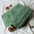 Bengal Cotton Saree With Self-Woven Floral And Spiral Motifs In Green Folded Display With Striped Border Close Up View