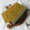 Bengal Cotton Saree With Self-Woven Floral And Spiral Motifs In Yellow Folded Display With Striped Border Close Up View