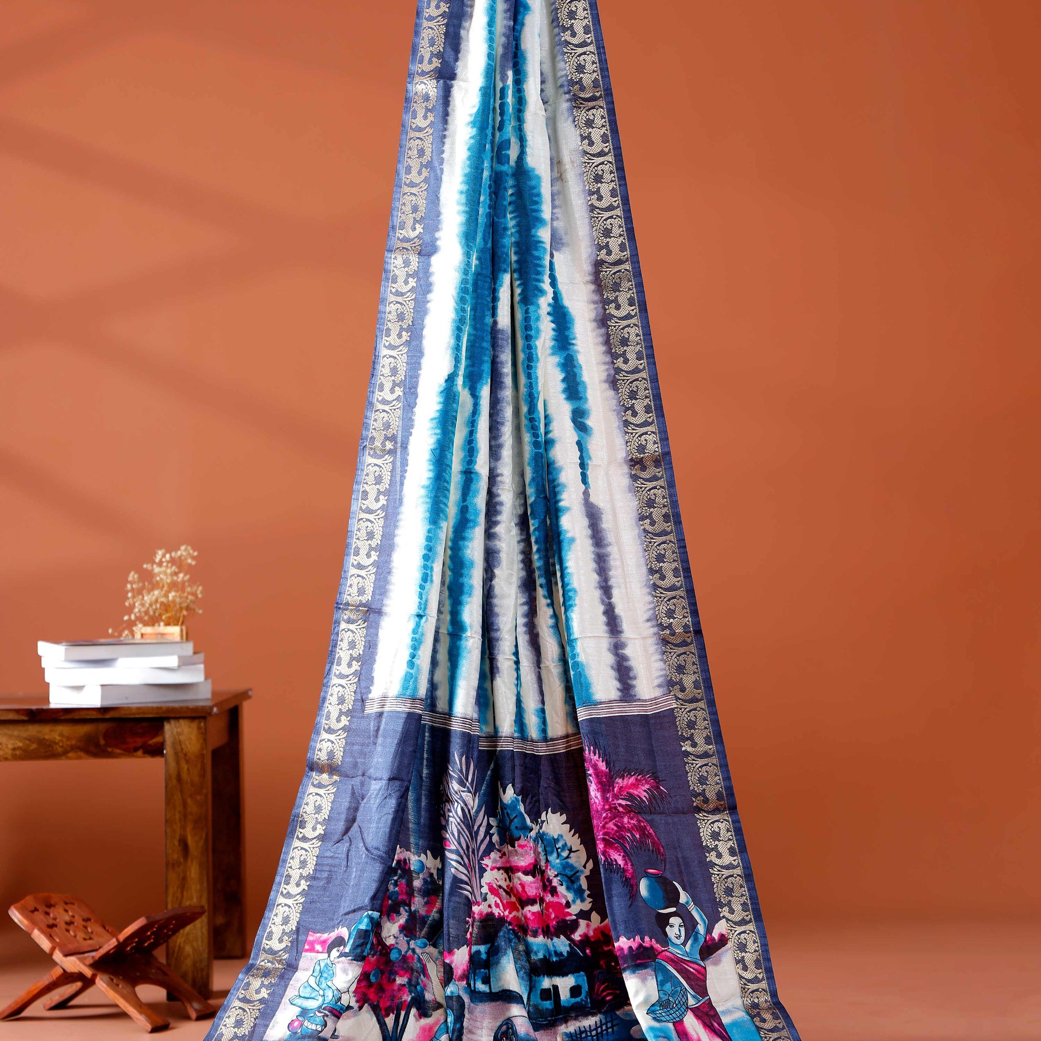 Elegant Navy Blue shades and the rural scenic artwork Dola Saree