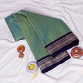 Folded Green Mangalagiri Cotton Saree With Traditional Navy Blue Zari Border Product Display View