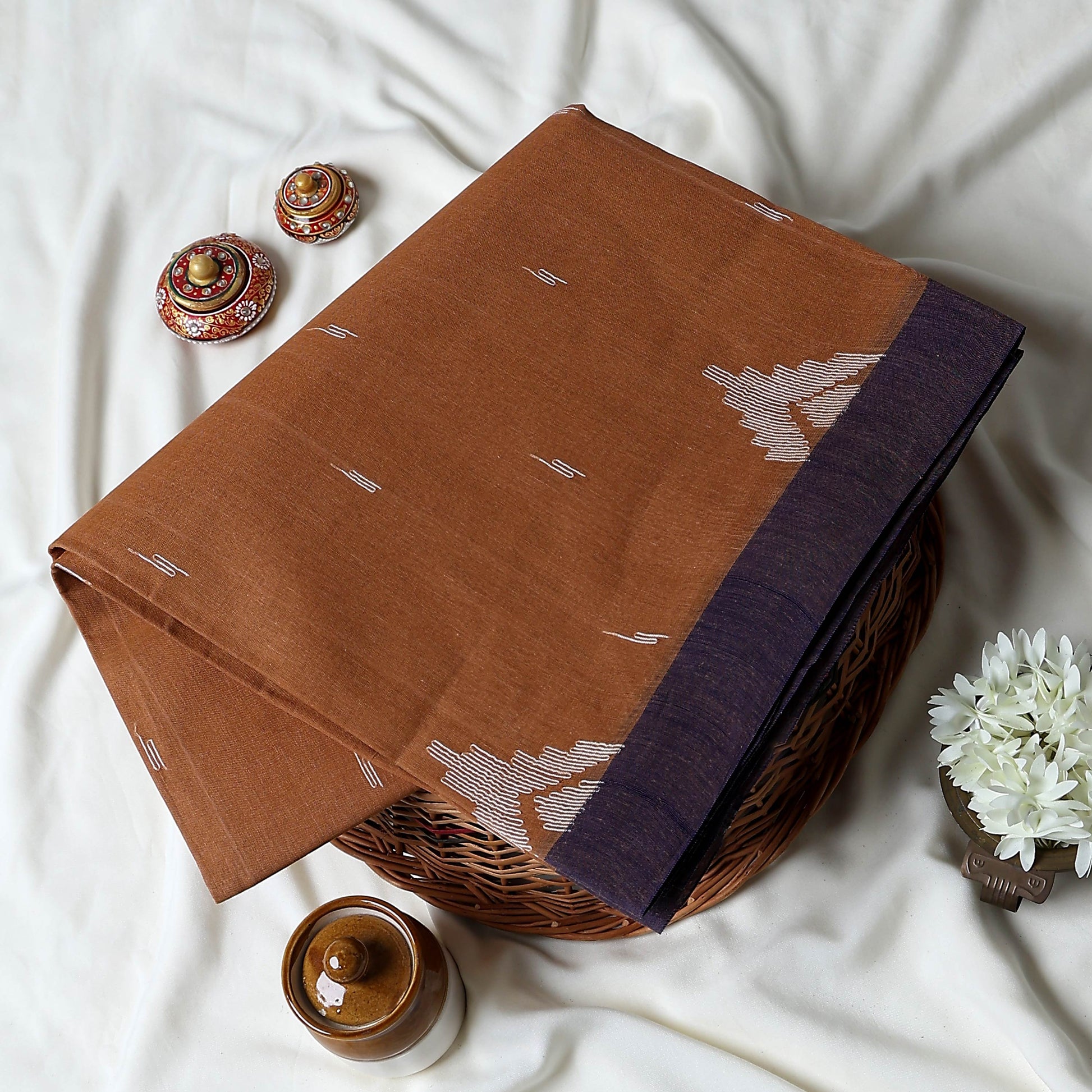 Bengal Cotton Saree With White Woven Butti Motifs And Plain Purple Border In Dark Brown Folded Flat View