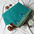 Bengal Cotton Saree With White Woven Butti Motifs And Plain Green Border In Aqua Blue Folded Flat View