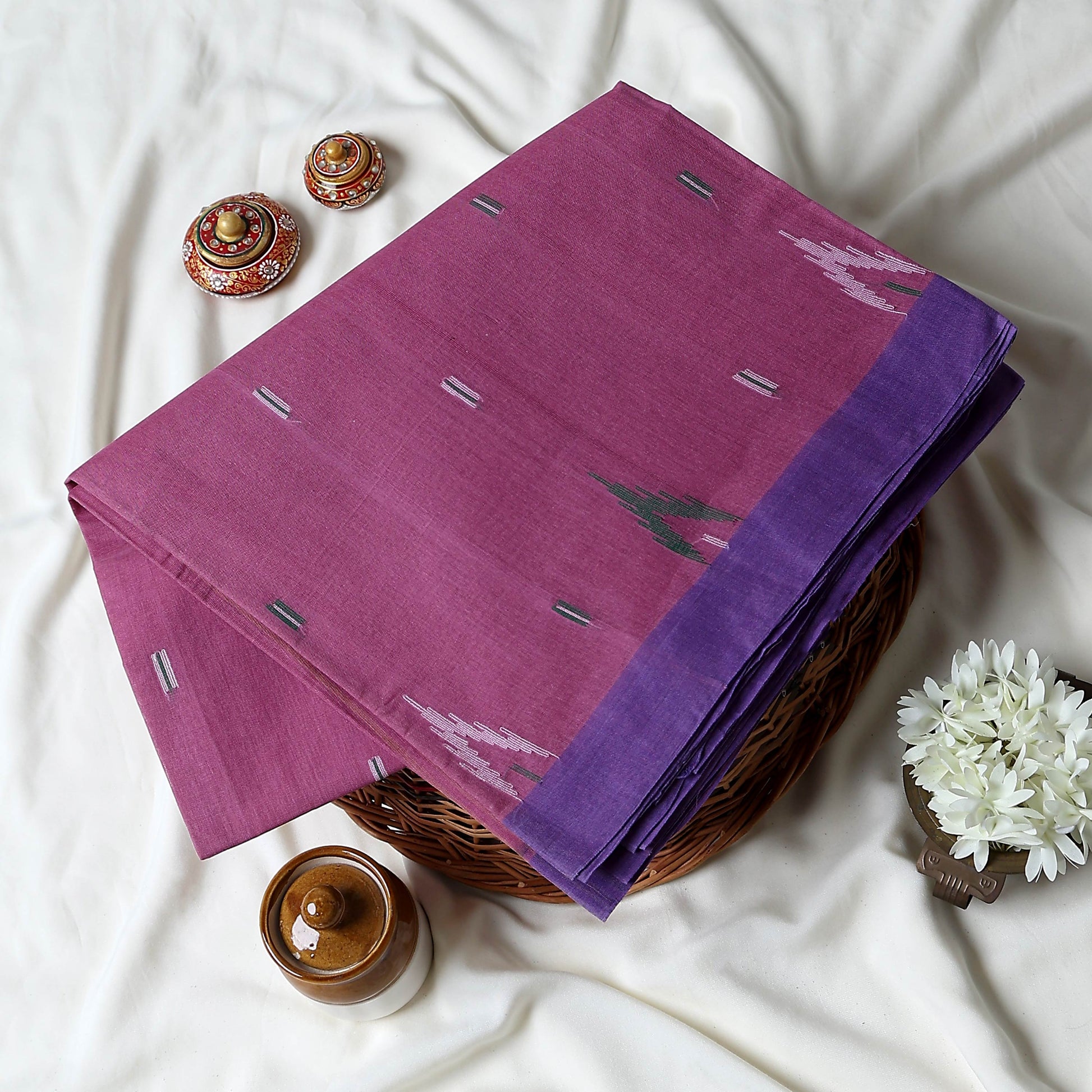 Bengal Cotton Saree With White Woven Butti Motifs And Plain Blue Border In Pink Folded Flat View