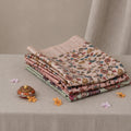 Tussar saree with multicolor artistic print, green woven border, neatly folded stack front view